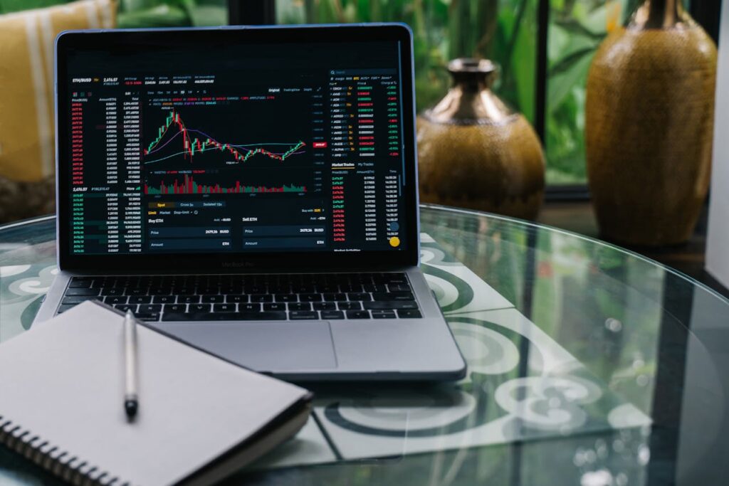 A laptop next to a notebook detailing discretionary vs. non-discretionary accounts