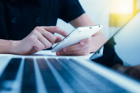 Person typing on a smartphone.