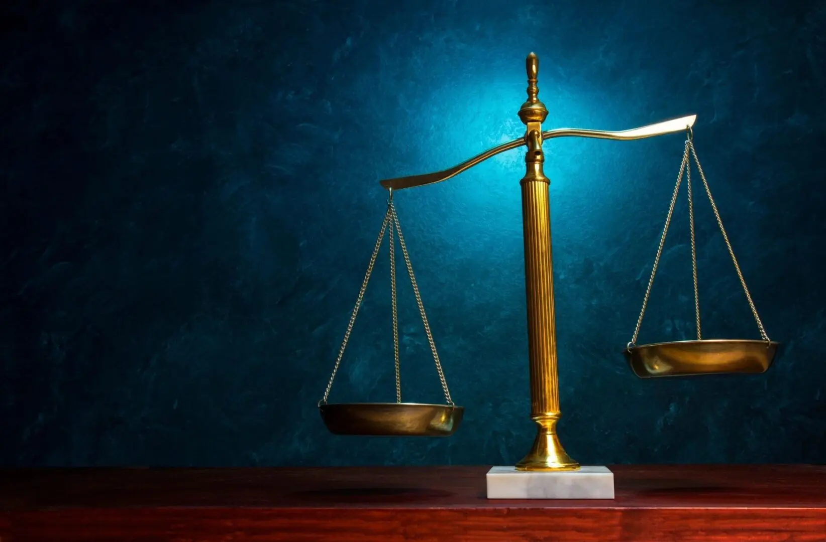The scales of justice on a table to represent legal wrongdoing, such as DARF investment losses sustained through false information