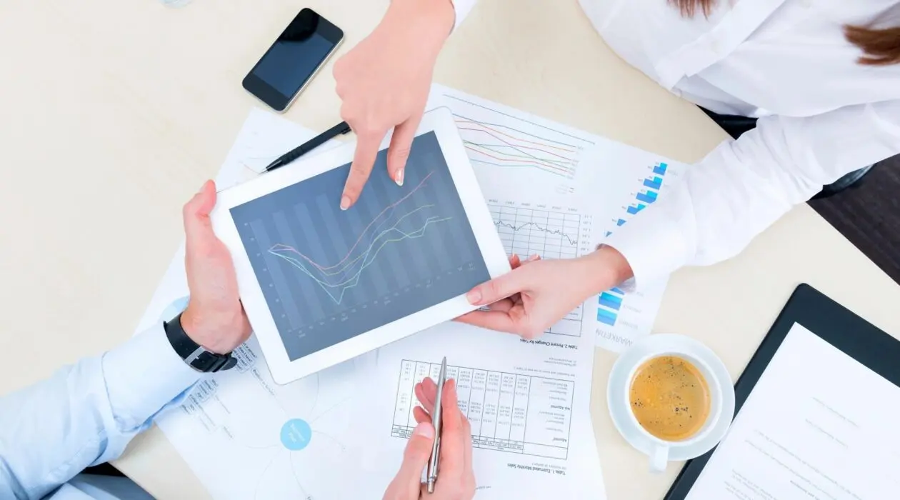 Two people using a tablet to discuss FINRA Rule 2111 suitability