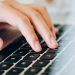 A person’s hand typing on a laptop to research Four Springs Capital 1031 DST investments
