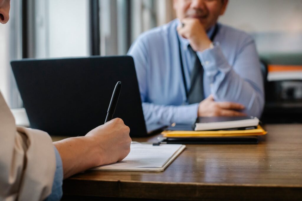 A person writing down information during an SEC review