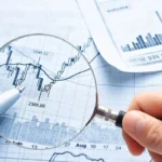 A person holding a magnifying glass over an option trading guide