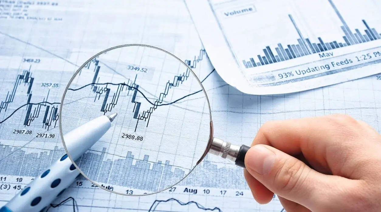 A person holding a magnifying glass over an option trading guide