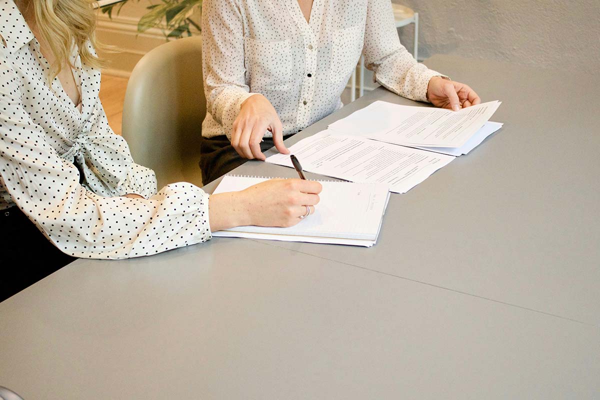 Two people looking over investment paperwork at a table