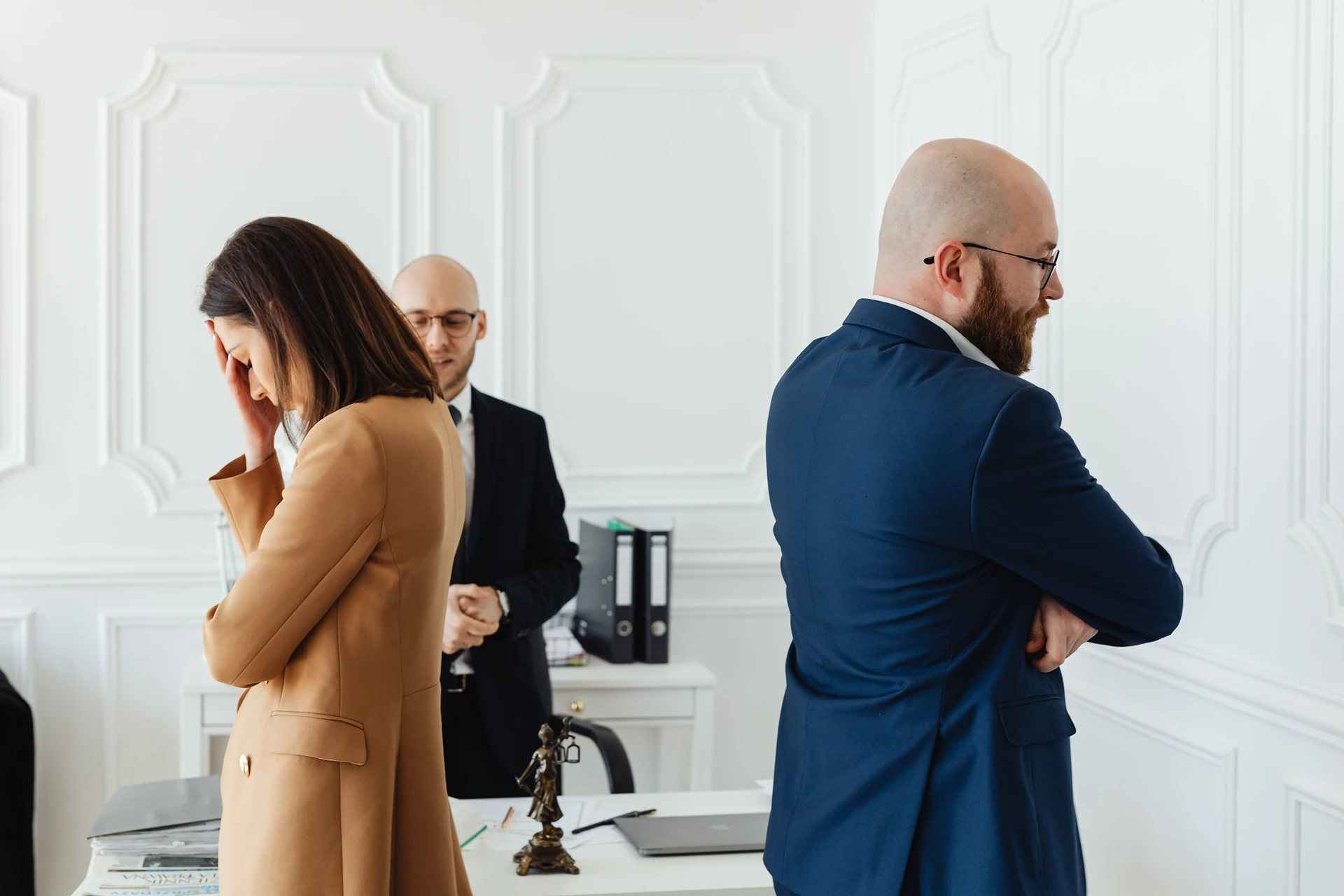 Two frustrated people with their backs to each other during an arbitration session