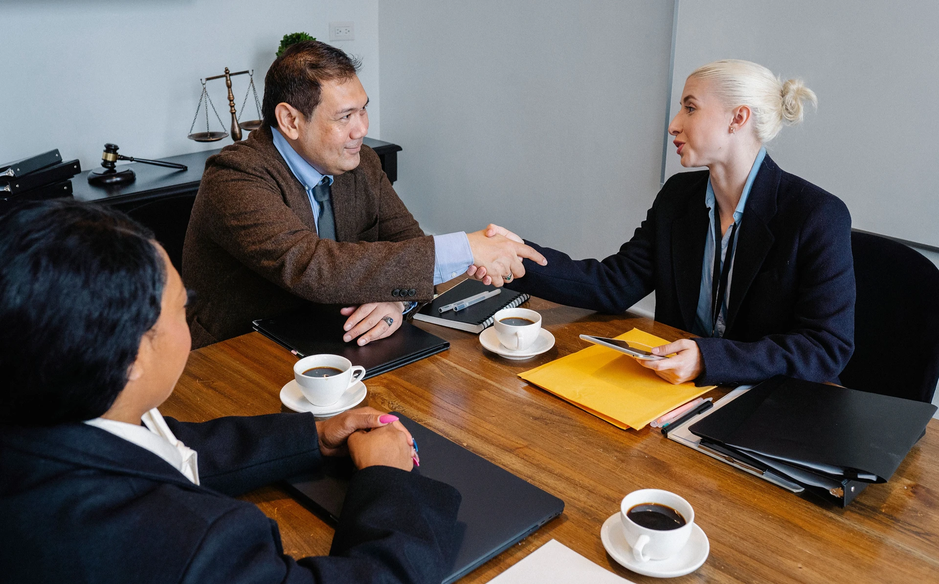 A man and woman shaking hands during the arbitrator selection process