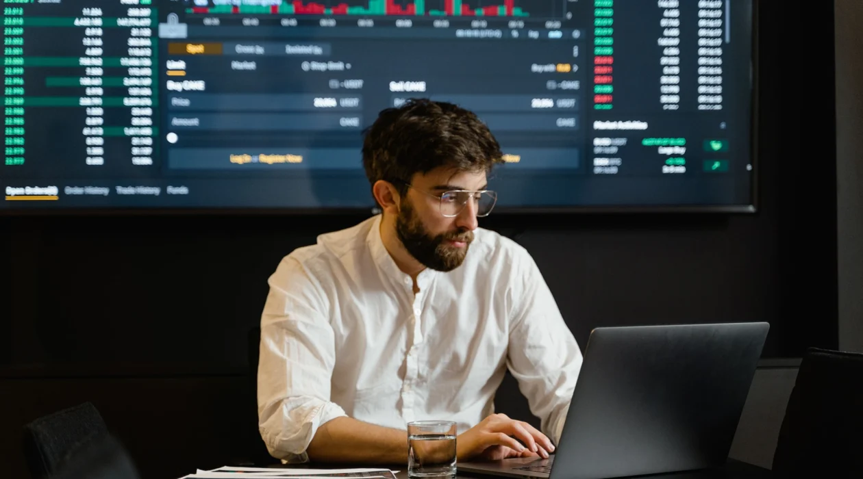 A broker working on a laptop.
