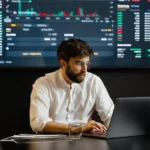 A broker working on a laptop.